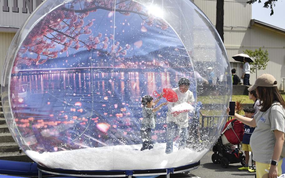 A man and his son in a snow globe.