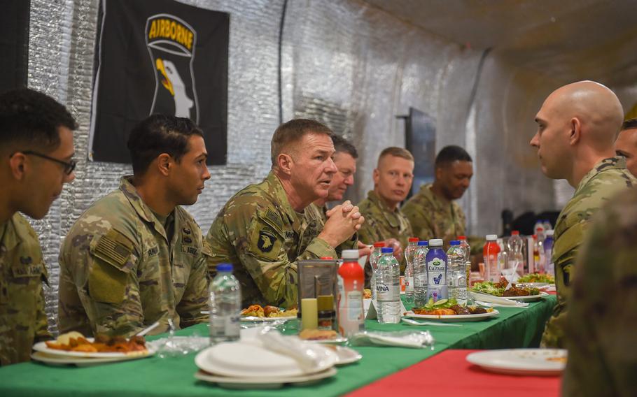 Army Chief of Staff Gen. James McConville eats lunch with soldiers at Mihail Koglniceanu Air Base, Romania, during his visit on Dec. 16, 2022. 