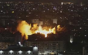 Flames and smoke rise from a building after the Israeli airstrike.