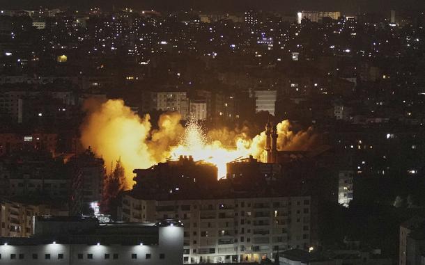Flames and smoke rise from a building after the Israeli airstrike.