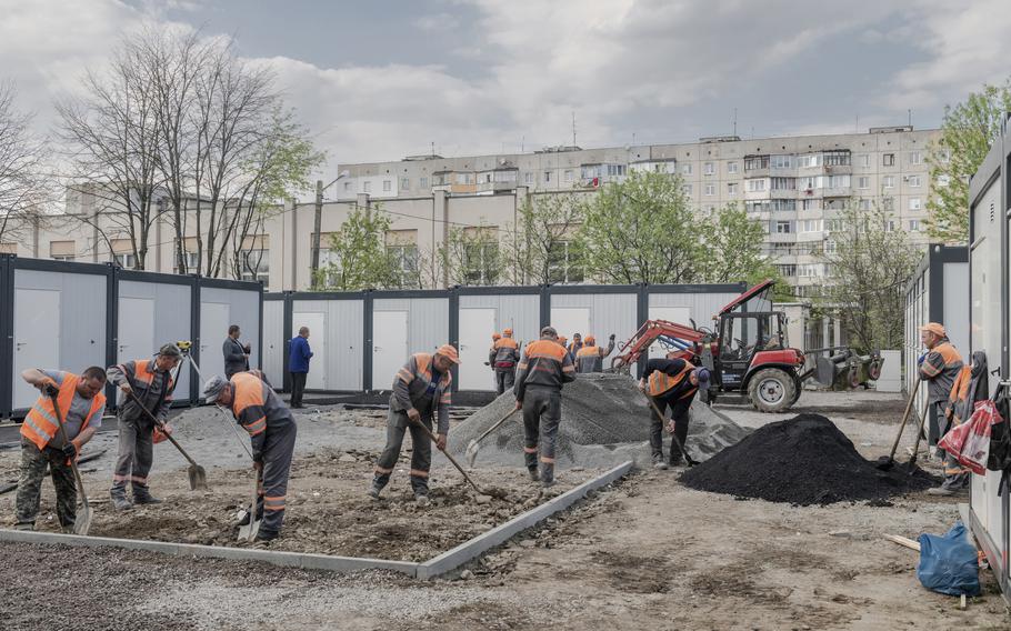 Workers at a construction site for temporary housing in Lviv, Ukraine, on May 2, 2022.