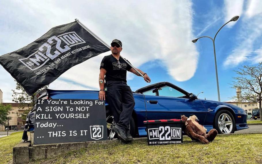 Air Force veteran Scot Northcutt often stands on Yokota Air Base, Japan, holding a sign with a jarring message: “If you are looking for a sign to not kill yourself today, this is it.” He spreads his message on behalf of Mission 22, an organization aimed at bringing awareness to veteran suicide. 