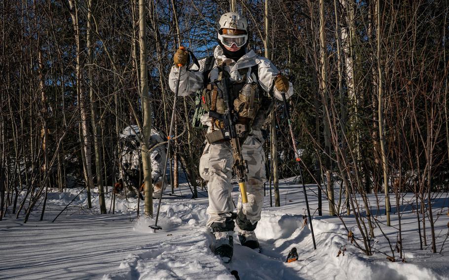 U.S. and Danish special operators move through terrain on skis on their way to a simulated attack. 