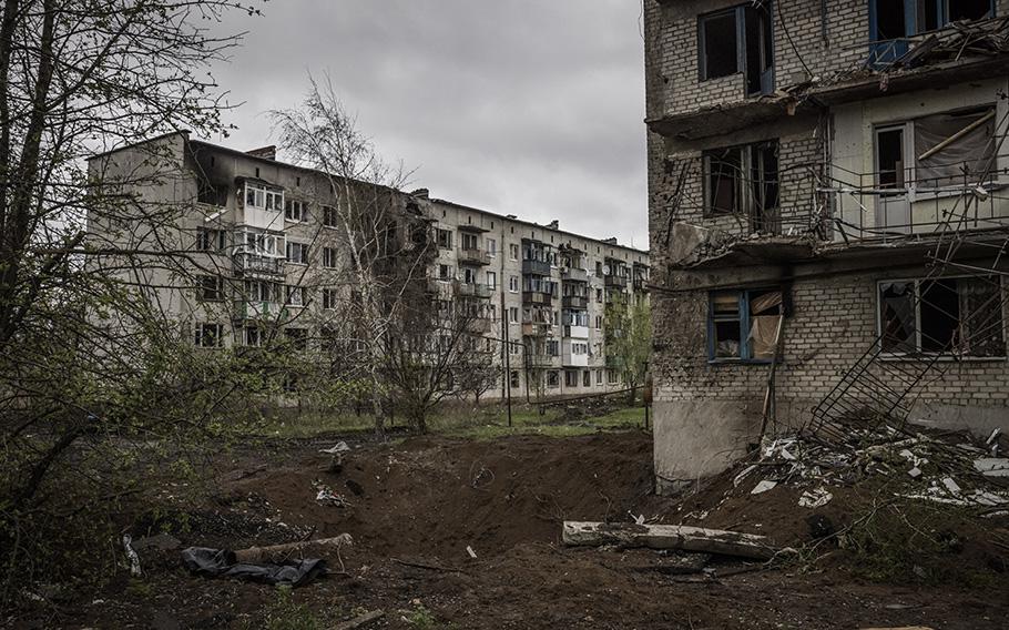 A crater is visible next to a block of apartments in Chasiv Yar, in Ukraine’s Donetsk region, on April 21, 2023. 