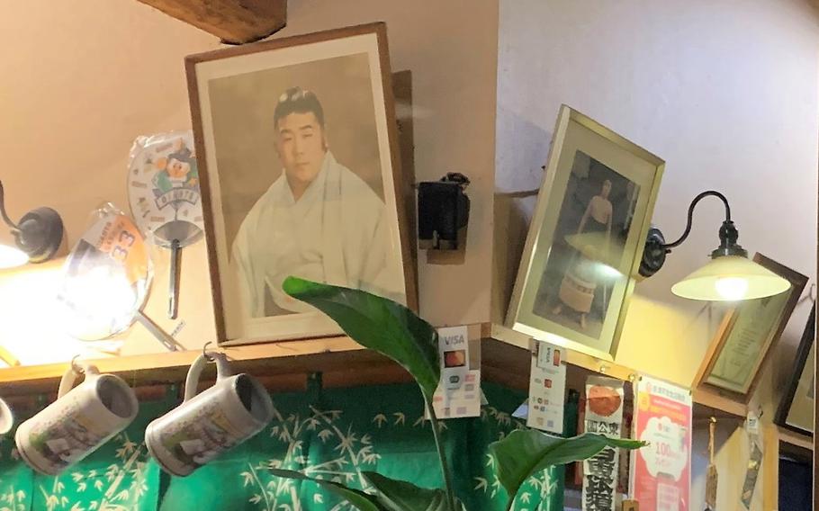 Framed photographs of the chef in his sumo wrestling years hang above the bar.