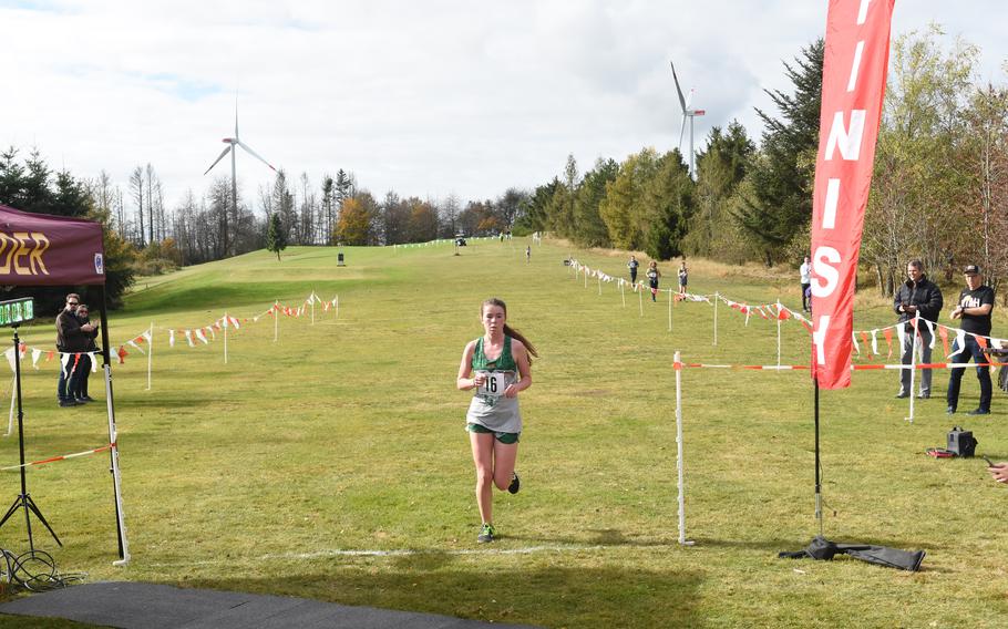 Finja Leibing of AFNORTH crosses the finish line in first in the girls’ small schools division race at the DODEA-Europe cross country championships on Saturday, Oct. 23, 2021. The 3.1-mile race was held at the Baumholder Rolling Hills Golf Course in Germany. Leibing ran a 22:30.20.