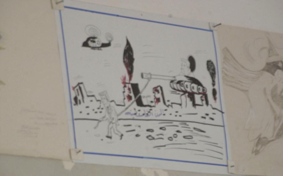 Hand-drawn children’s pictures, such as this one portraying President George W. Bush leading a tank through an Iraqi town, were found in both the school in Al Fahr and the adjacent Baath Party headquarters building.  