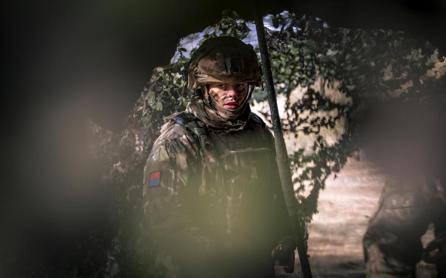 A U.K. soldier stands at his unit’s command and control center during an exercise. 