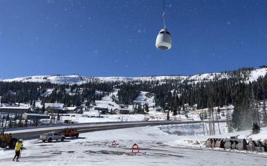 A helicopter picks up an egg-shaped remote avalanche exploder, which it transported to an area near U.S. 160 Wolf Creek Pass in southwest Colorado in November 2022. (Colorado Department of Transportation/Stateline.org/TNS)