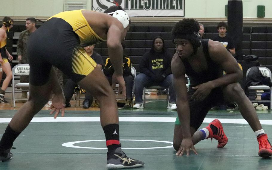 Kadena's James Kinney and Kubasaki's Godfrey Wray stare down each other at 141 pouonds during Wednesday's Okinawa wrestling dual meet. Kinney won an 8-5 decision and the Panthers won the meet 31-31 by virtue of more individual bout wins.