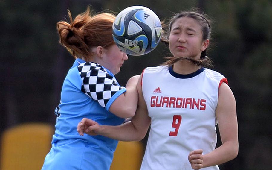 Osan's Elysia Koch and Yongsan International-Seoul's Sophie Cho go up to head the ball during Friday's Korea girls soccer match. The Guardians won 2-1.