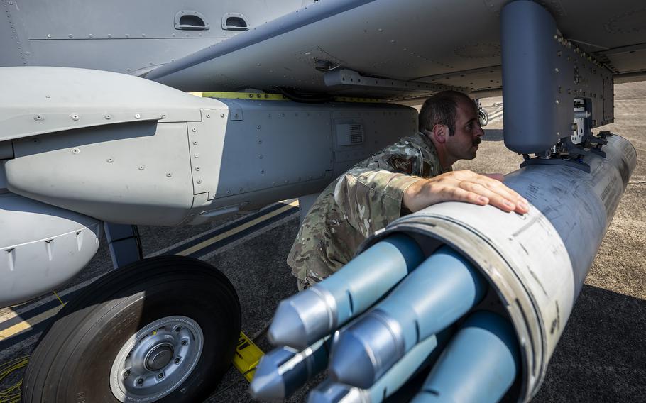 An airman performs preflight checks.