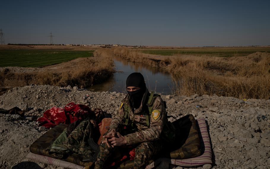 Amir, a fighter with a U.S.-backed Syrian force, is shown at a checkpoint in Raqqa governorate on Feb. 5. 