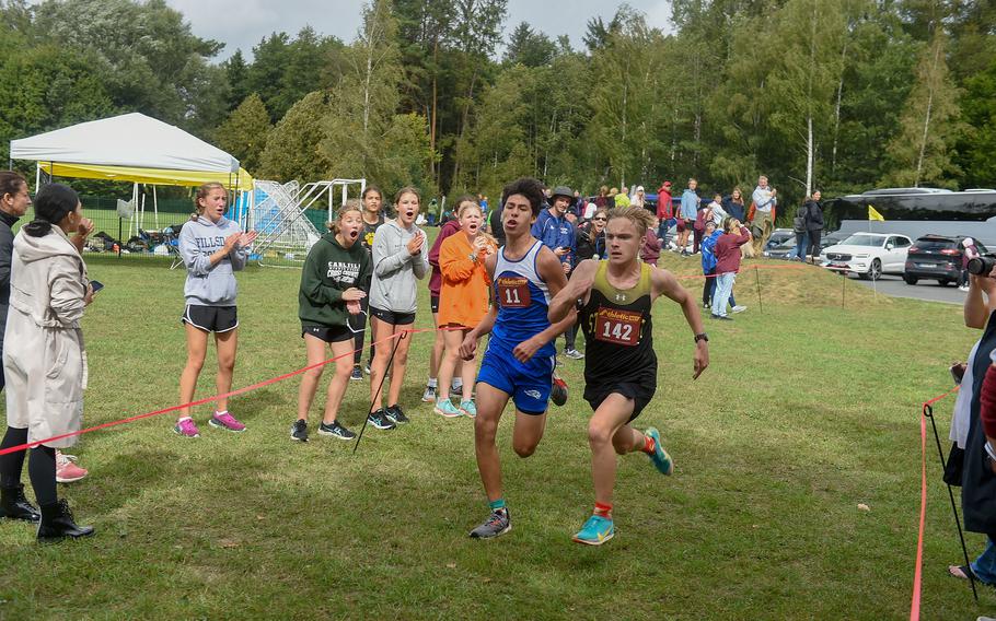 Stuttgart runner Charles Stewart, right, and Ramstein runner Ryan Izaguirre battle toward the finish line of the boys 3.1-mile cross country race at Vilseck, Germany, Saturday, Sept. 10, 2022.