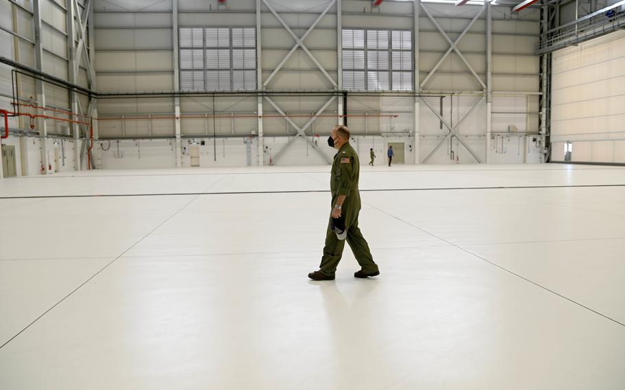 Capt. Tim Thompson, head of Commander Task Force 67, walks through the new P-8 Poseidon hangar at Naval Air Station Sigonella, Italy, Feb. 2, 2022. 