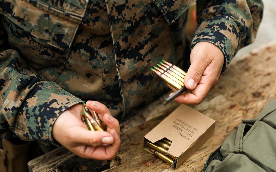 A Marine separates ammunition during a field exercise on a range at Camp Schwab, Okinawa, Dec. 5, 2020. 