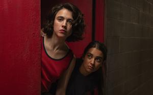 Geraldine Viswanathan, right, and Margaret Qualley go on a unique road trip in “Drive-Away Girls.” 