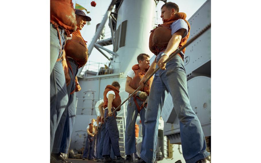 Sailors pull rope during the refueling and rearming operation on board the USS Buchanan destroyer by the tanker USS Tappahannock (not visible). 