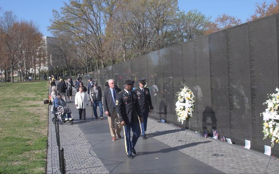The United States of America Vietnam War Commemoration hosted a wreath-laying ceremony at the Vietnam Veterans Memorial on National Vietnam War Veterans Day, to thank and honor Vietnam veterans and to honor their legacy of service, in this screenshot from video.