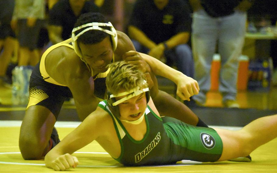 Kadena's James Kinney gains the edge on Kubasaki's Brady Potter at 141 pounds during Wednesday's Okinawa wrestling dual meet. Kinney pinned Potter in 2 minutes, 7 seconds, but the Dragons won the meet 39-26.