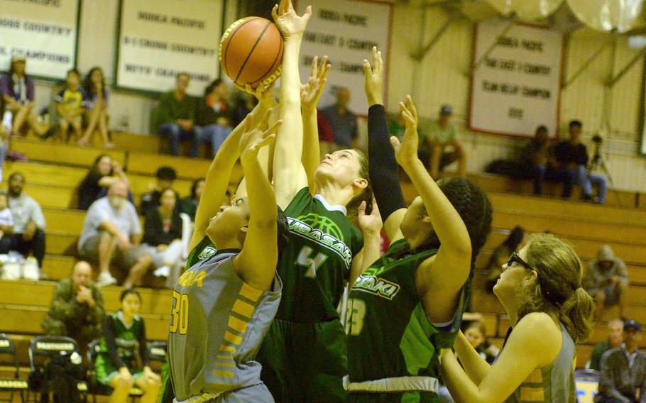 Kadena's Reina Ovene, Kubasaki's Adria Lockhart and Kadence Johnson and Kadena's Marina Sawyer look to rebound during Friday's DODEA-Okinawa girls basketball game. The Panthers won 40-12.