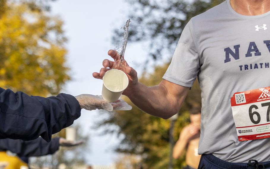 A runner attempts to grab a cup of water