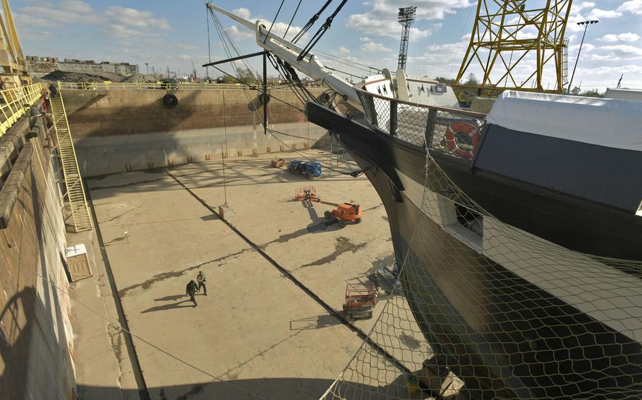 Workers descend 60 steps to the floor of the dry dock where the USS Constellation was being repaired. The ship returned to the Inner Harbor on Monday, Dec. 19, after eight weeks of repairs at Tradepoint Atlantic Shipyard.