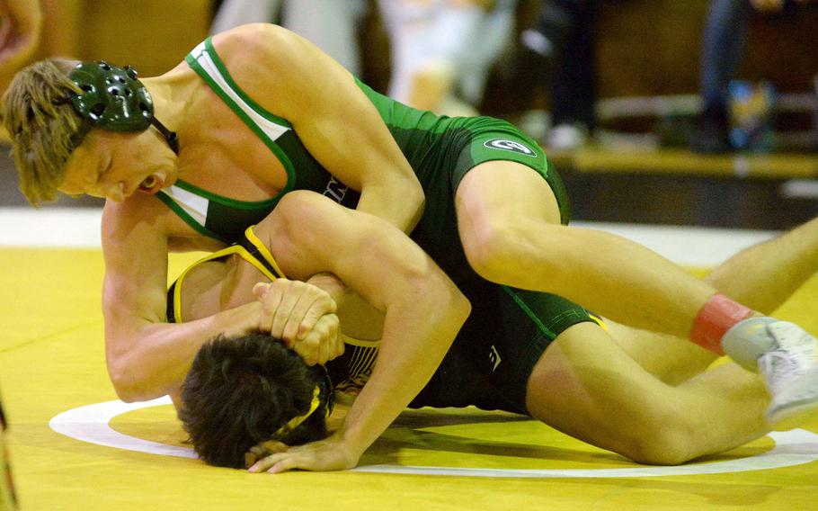 Kubasaki 145-pounder Brady Potter gets the advantage on Kadena's Austin Lutz during Wednesday's Okinawa wrestling dual meet. Potter pinned Lutz in 2 minutes, 11 seconds but the Panthers won the meet 40-23, improving to 3-0 over the Dragons this season.