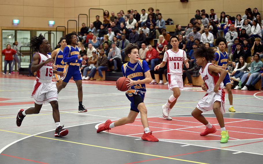 Wiesbaden's Gavin DeLuca drives to the bucket as Kaiserslautern's Sevastian Quiles defends on Friday evening at Kaiserslautern High School in Kaiserslautern, Germany. Following the play are the Radiers' Davis Martin, left, and Jayden Dayao, middle right.