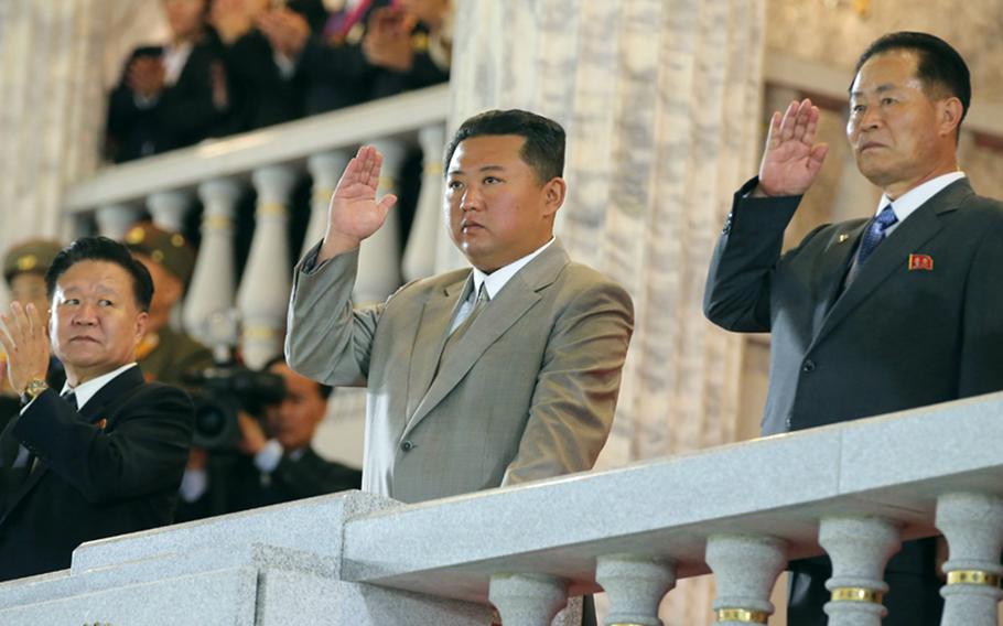 This image from the state-run Rodong Sinmun newspaper shows North Korean leader Kim Jong Un, center, attending a military parade in Pyongyang, early Thursday, Sept. 9, 2021.