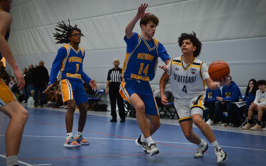 Stuttgart's Ismael Anglada-Paz drives to the basket past Wiesbaden's Collin Koschnik during the Division I boys basketball championships at Ramstein Air Base in Germany on Feb. 16, 2023.
