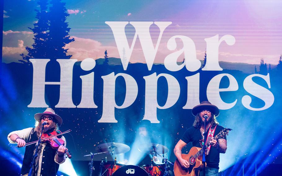 Country music duo War Hippies performs March 9, 2023, at MadLife Stage & Studios in Woodstock, Ga., just north of Atlanta, during the band’s 2023 tour in support of their self-titled debut album. Both War Hippies members, Marine veteran and guitarist Scooter Brown, right, and Army veteran and violinist Donnie Reis, left, are Iraq War veterans.