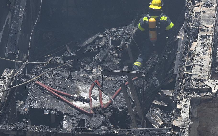 This photo supplied by the City of Cape Town shows a fireman fighting a fire at the Houses of Parliament, in Cape Town, South Africa, Sunday, Jan. 2, 2022. Firefighters are still working at the Parliament complex Monday after a major blaze tore through the precinct Sunday.