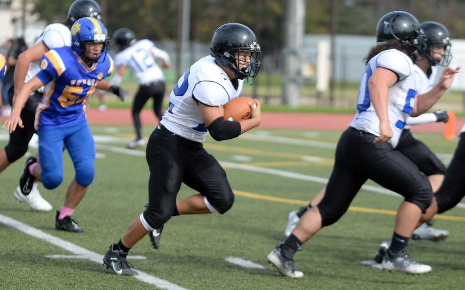 Osan's Eddie Kim gets an escort for his second of two trips to the end zone.