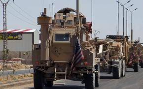 An American military armored vehicle displaying a cross and the word “Kafir,” Arabic for infidel, patrols near Hasakah, Syria, May 31, 2025. An investigation was launched into whether the writing on the vehicle violates Defense Department policy.