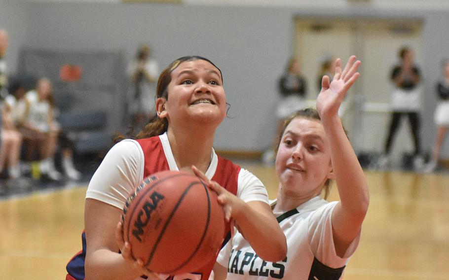 Aviano's Joyce Taylor goes up for a shot while defended by Naples' Emma Kasparek in the Wildcats' 35-20 victory over the Saints on Saturday, Jan. 7, 2023.