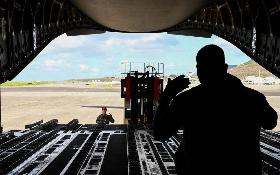 U.S. Air Force Tech. Sgt. James Delgadillo, 58th Airlift Squadron instructor loadmaster, directs a forklift at Marine Corps Base Hawaii, Sept. 9, 2021. More than 30,000 pounds of MQ-9 Reaper assets were loaded in support of exercise Agile Combat Employment Reaper.