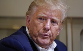 Former President Donald Trump listens as he speaks with reporters while in flight on his plane after a campaign rally at Waco Regional Airport, in Waco, Texas, Saturday, March 25, 2023, while en route to West Palm Beach, Fla. (AP Photo/Evan Vucci)