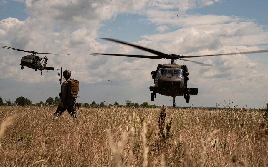 A combat controller assigned to the 352nd Special Operations Wing controls the landing of two U.S. Army UH-60s during NATO training near Daugavpils, Latvia, June 28, 2023. The Senate on July 19 passed an amendment to the 2024 defense authorization bill that would prevent any president from unilaterally pulling out of NATO.