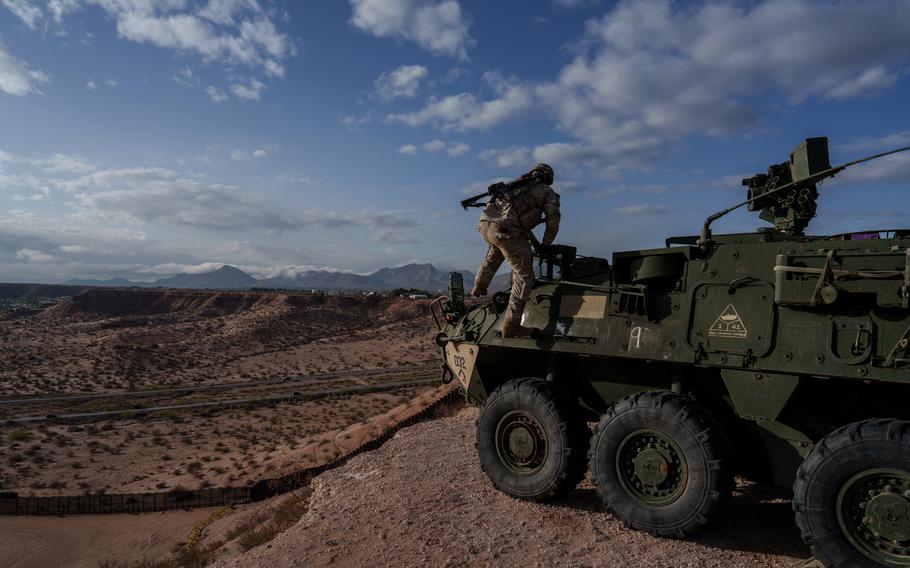 A U.S. soldier dismounts his Stryker armored infantry transport.