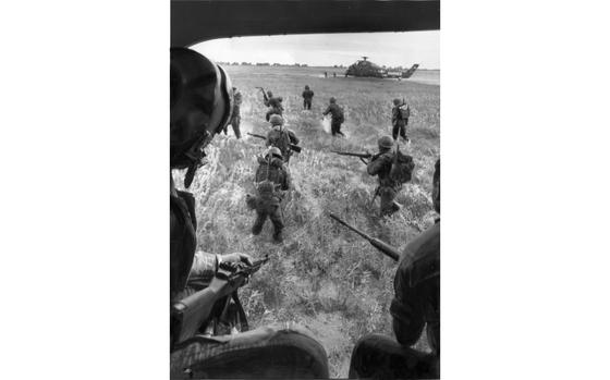 Ba Xuyen province, South Vietnam, August 1962: Soldiers of the 1st Vietnamese Airborne Battalion jump out of the helicopter into a muddy waterlogged field near a canal village in Ba Xuyen province. The soldiers were airlifted by helicopters of the U.S. Army and U.S. Marine Corps to the southern regions of the country to conduct military operations against the Viet Cong there. U.S. advisor Capt. John F.C. Kenney accompanied the battalion.

Pictured here is a scan of the original 1962 print created by Stars and Stripes Pacific's photo department to run in the print newspaper. As all pre-1964 Stars and Stripes Pacific negatives and slides were unwittingly destroyed by poor temporary storage in 1963, the prints developed from the late 1940s through 1963 are the only images left of Stripes' news photography from those decades. These include images from America's early engagement in Vietnam. Stars and Stripes' archives team is scanning these prints to ensure their preservation. 

Looking for Stars and Stripes’ coverage of the Vietnam War? Subscribe to Stars and Stripes’ historic newspaper archive! We have digitized our 1948-1999 European and Pacific editions, as well as several of our WWII editions and made them available online through https://starsandstripes.newspaperarchive.com/

META TAGS: Pacific; South Vietnam; Vietnamese army; 1st Vietnamese Airborne Battalion; U.S. advisors; Vietnamese Airborne Advisory Detachment; combat; Military Assistance Command Vietnam; MACV; Vietnam War; helicopters; U.S. Army; USMC; U.S. Marine Corps