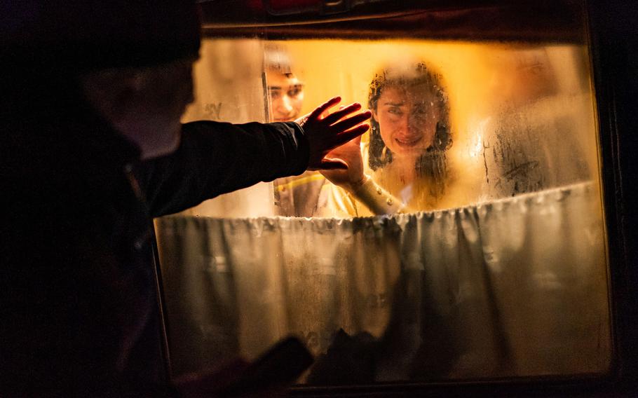 George Keburia says goodbye to his wife Maya and children as they board a train to Lviv at the Odessa train station in Odessa, Ukraine on March 5, 2022.