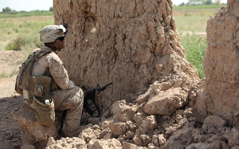 A U.S. Marine combat engineer takes cover in Marjah, Afghanistan. Navy officials have agreed to review and potentially upgrade thousands of discharge cases for Navy and Marine Corps veterans who struggled with PTSD and other mental health conditions following their service in Afghanistan and Iraq.