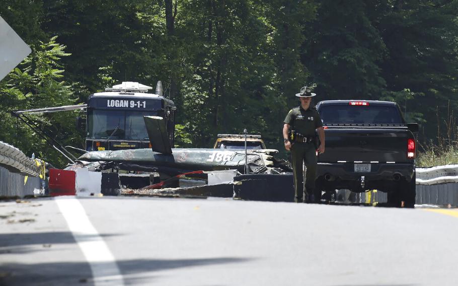 Emergency personnel look over the sight of a helicopter that crashed in Blair, W.Va., on Thursday, June, 23, 2022.