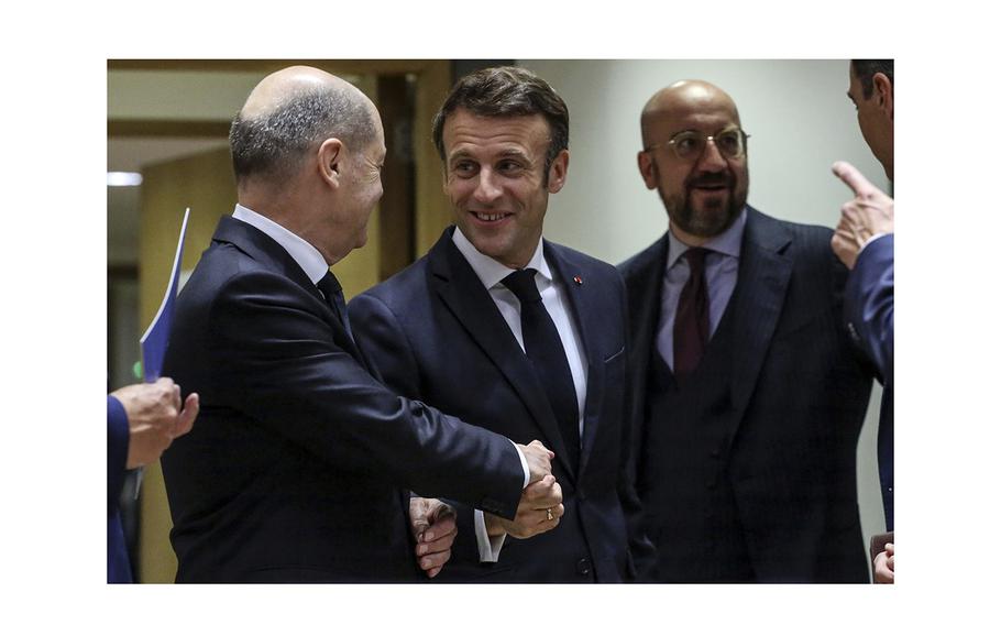 Olaf Scholz greets Emmanuel Macronat the European Union leaders summit in Brussels, Belgium, on Oct. 21, 2022.