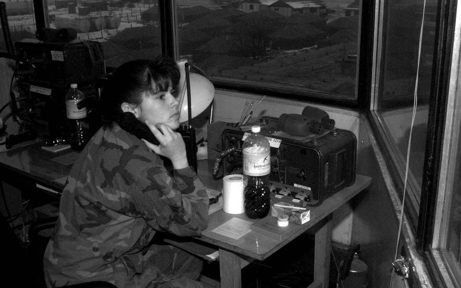 Taszar AB, Hungary, January, 1996: 
An airman looks out over Taszar's airfield while on duty within the air traffic control tower. 