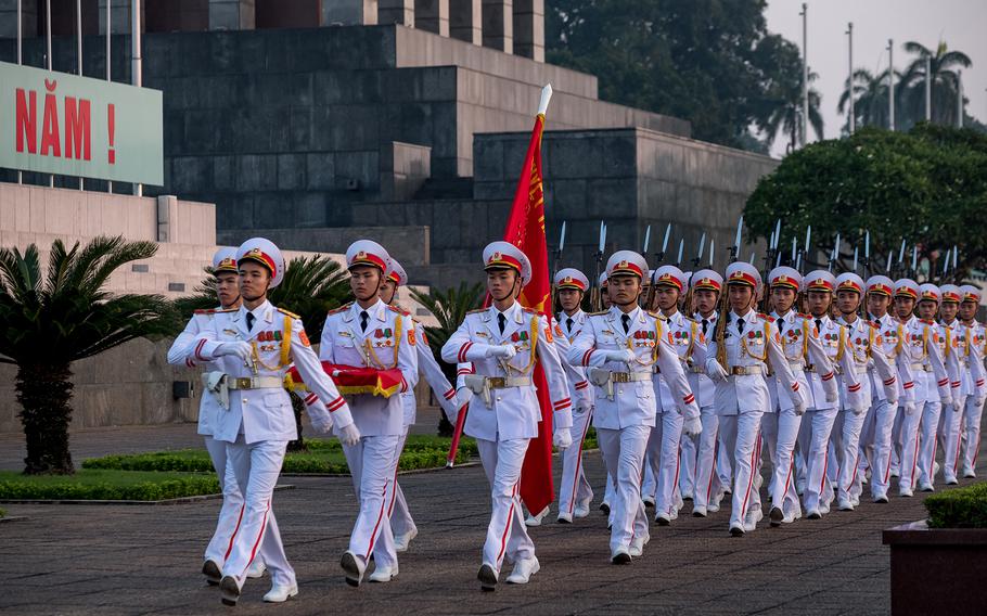 Military honor guards march during a flag-raising ceremony at Ba Dinh Square in Hanoi on Sept. 25, 2018. 