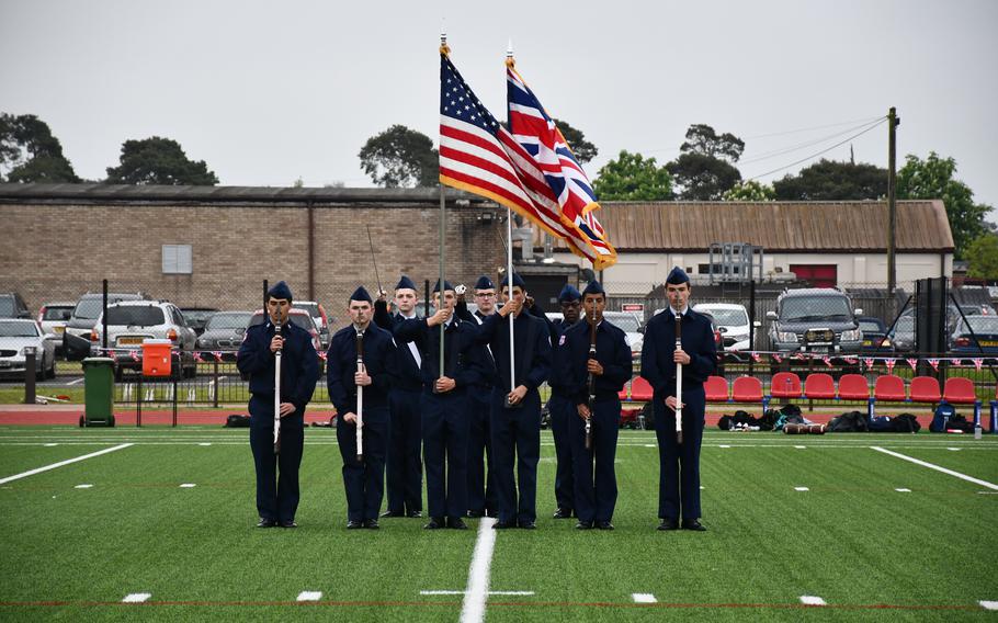 RAF Lakenheath High Schools JROTC flag detail raise both the American and United Kingdom flags during the opening ceremony of a service flag football game at RAF Lakenheath on Friday. The game was sponsored by the NFL’s New York Jets.