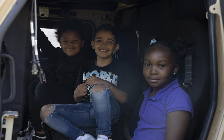 Students at Oaks Road Academy pose for a photo inside a Joint Light Tactical Vehicle during a career fair in New Bern, N.C., Friday, April 19, 2024. 