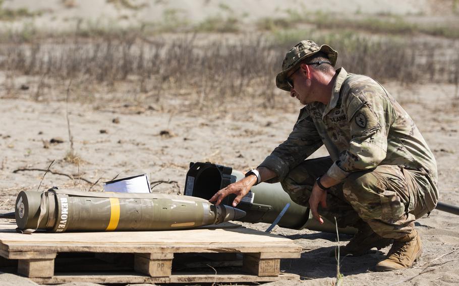 U.S. Army 1st Sgt. Louis Picciurro, of the 7th Field Artillery Regiment, inspects an Excalibur 155 mm artillery shell during Balikatan training in Laoag, Philippines, May 8, 2024.